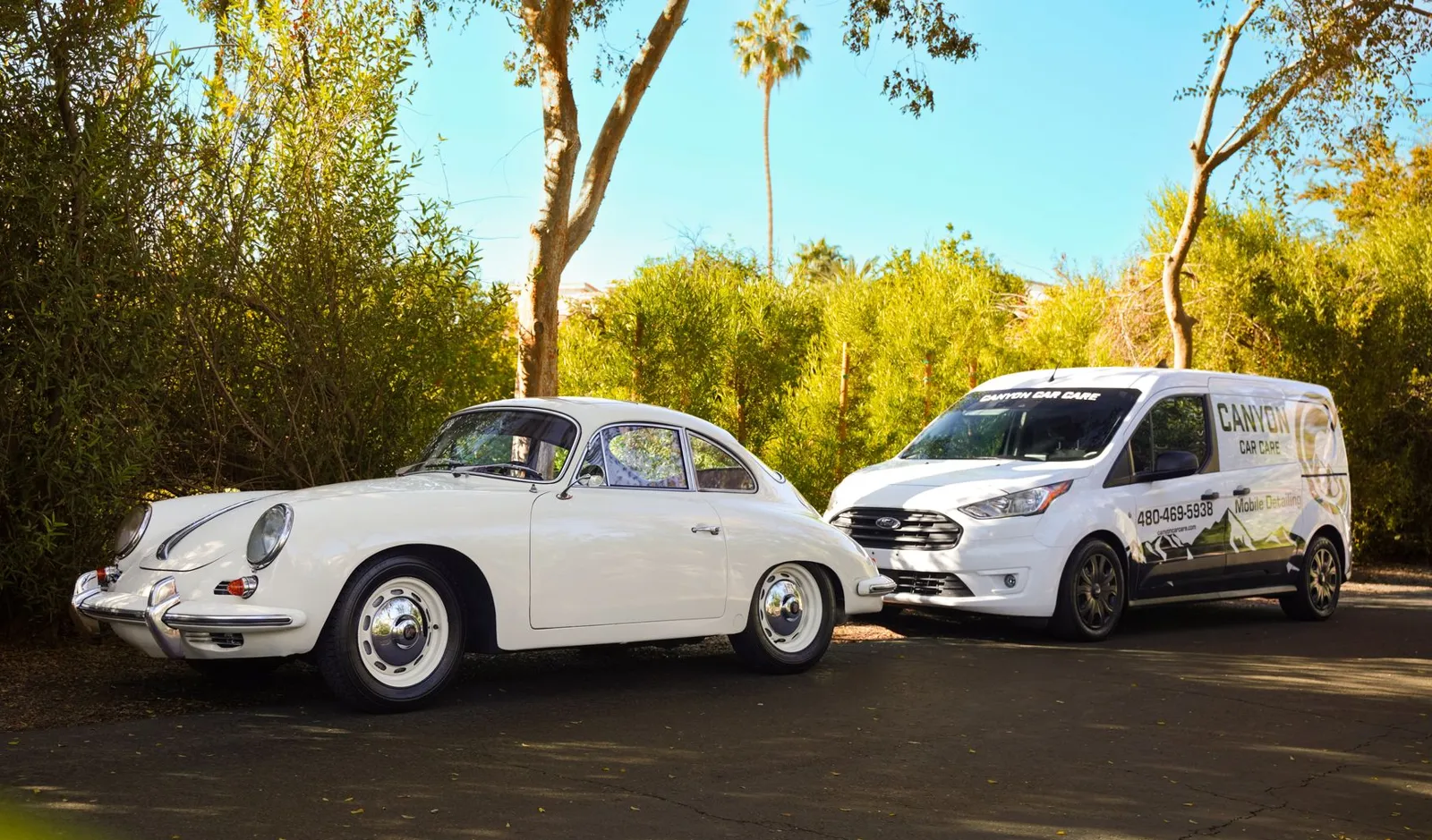 Classic white Porsche beside the Canyon Car Care mobile detailing van
